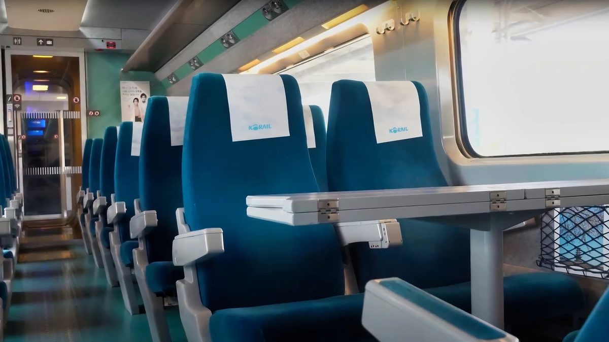 Standard Class carriage on a Seoul to Busan high-speed train, rows of reserved seats with large windows